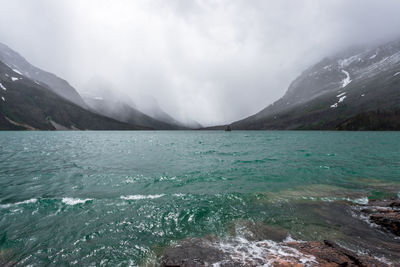 Scenic view of mountains against cloudy sky