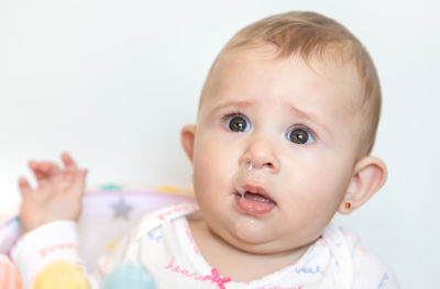 Baby girl with mucus coming out from nose at home