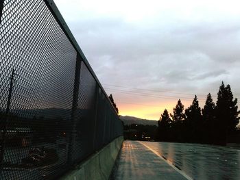 Road against cloudy sky at sunset