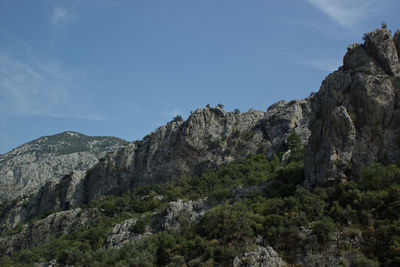 Low angle view of rocky mountains against sky