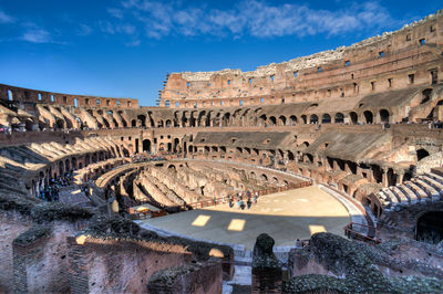 High angle view of coliseum against blue sky