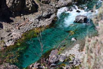 High angle view of stream flowing on sunny day