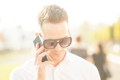 Portrait of man holding mobile phone