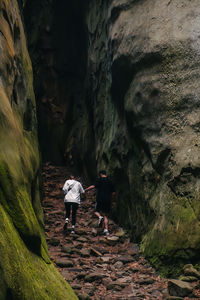 Rear view of man standing on rock