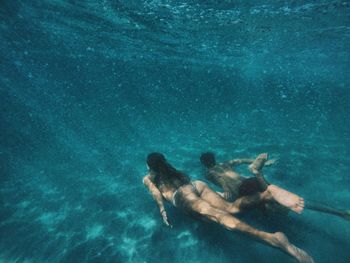 Couple swimming in sea