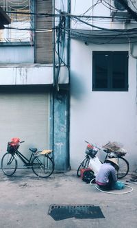 Bicycle parked against wall in city