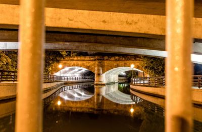 Illuminated bridge in city at night