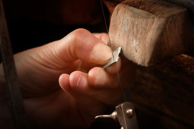 Cropped hand of manual worker working in factory