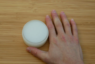 High angle view of person hand on table