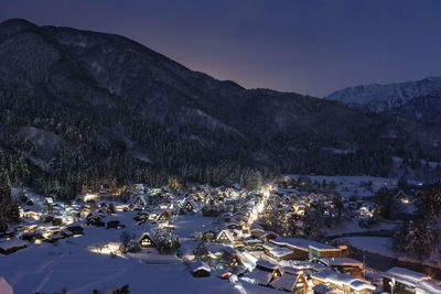 Aerial view of snowcapped mountains against sky during winter