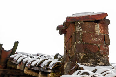 Low angle view of rusty built structure against clear sky