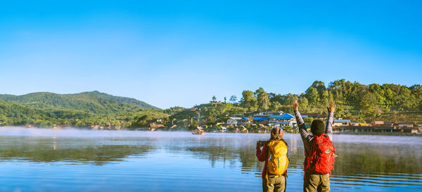 Rear view of woman standing in lake