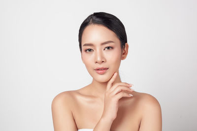 Portrait of a beautiful young woman over white background