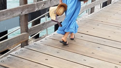 Low section of woman on wooden floor