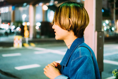 Portrait of woman looking at city