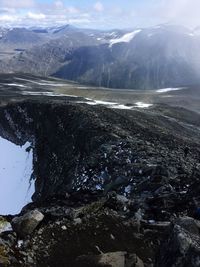 Scenic view of lake by mountains against sky