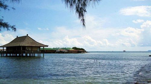 Scenic view of sea against cloudy sky