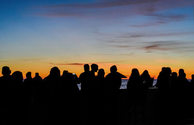 Silhouette people against sky during sunset