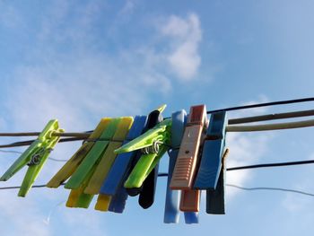 Low angle view of clothes hanging on clothesline against sky