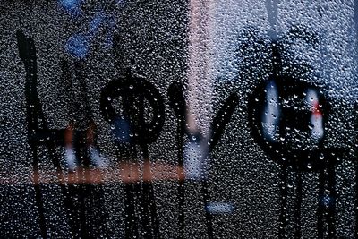 Close-up of wet glass window in rainy season