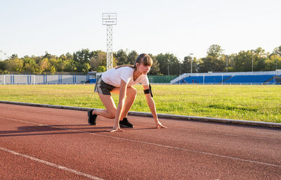 Full length of woman with on running track