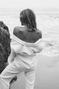 Rear view of girl standing at beach