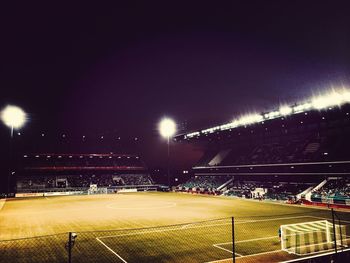 Group of people on soccer field at night