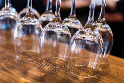 Close-up of wineglasses on wooden table