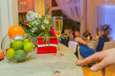 Midsection of woman with fruits on table