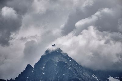 Low angle view of snowcapped mountain against sky