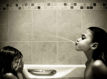 Portrait of shirtless boy in bathroom