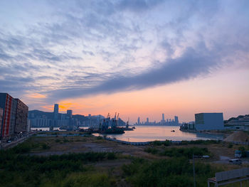 Buildings in city during sunset