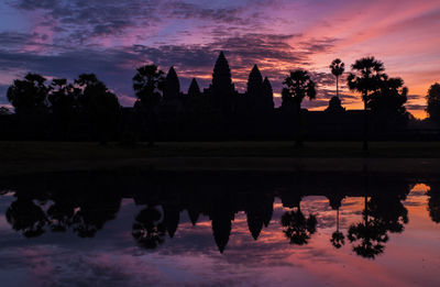 Reflection of trees in lake during sunset