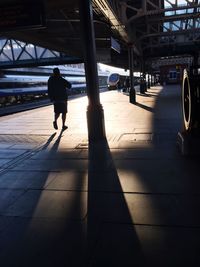 Full length of woman standing on railing