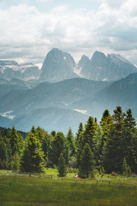 Scenic view of mountains against cloudy sky