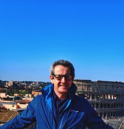 Portrait of man against blue sky