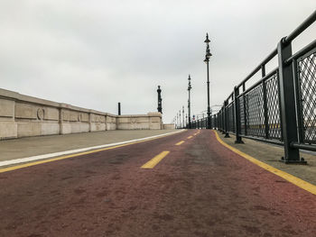 Surface level of road against sky in city