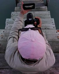 Rear view of man photographing camera