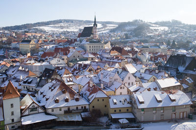 High angle view of houses in town against sky