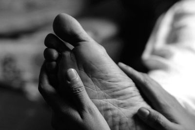 Close-up of hands touching feet