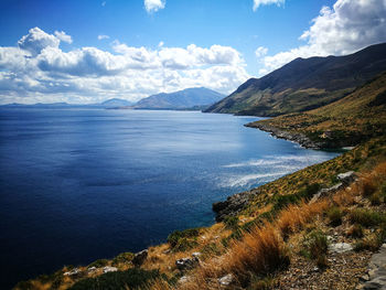 Scenic view of lake and mountains against sky