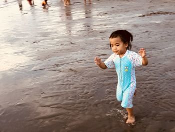 High angle view of girl running at beach