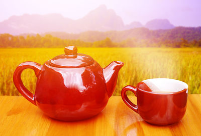 Tea cup on table against sky