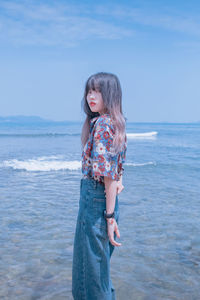 Young woman standing at beach