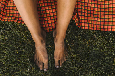 High angle view of bare feet on grass barefoot