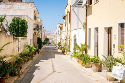 Footpath amidst buildings in city