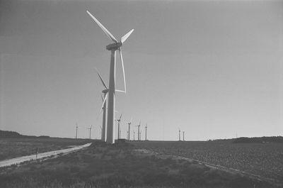 Windmill on field against clear sky