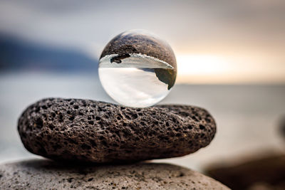 Close-up of crystal ball on rock