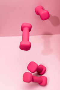 Close-up of chess pieces on pink background