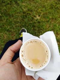 Low section of person holding coffee cup